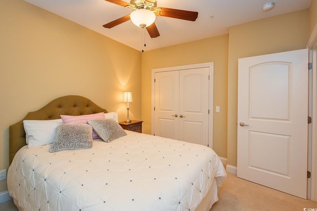 Bedroom with light carpet, a closet, and ceiling fan | Image 25