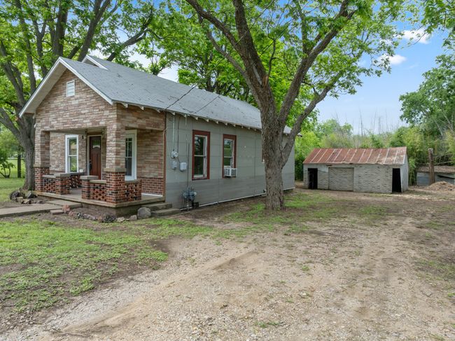 View of front of home with an outbuilding and cooling unit | Image 6