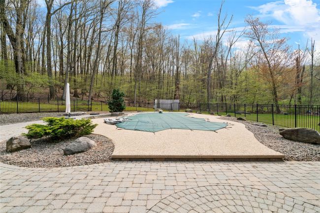 View of swimming pool featuring a fenced in pool, fence, and a patio area | Image 33