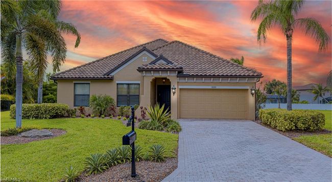 Mediterranean / spanish-style home featuring a tiled roof, stucco siding, a lawn, decorative driveway, and a garage | Image 31