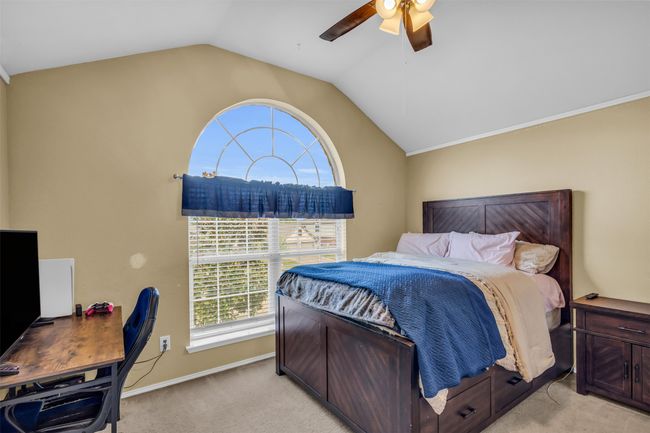 Carpeted bedroom with lofted ceiling and ceiling fan | Image 28