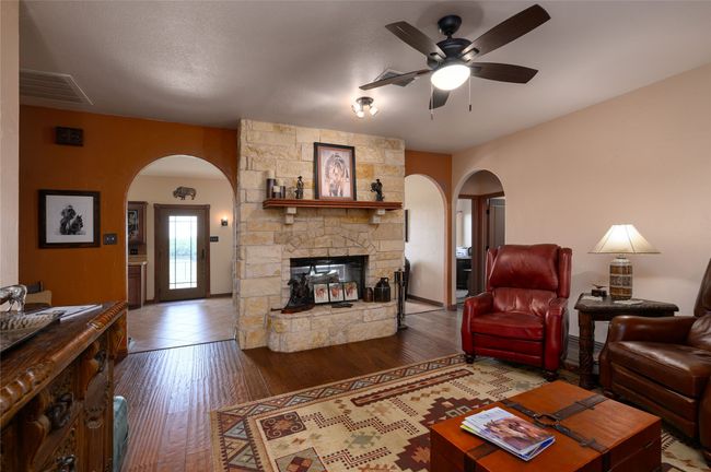living room featuring cozy fireplace and architectural details | Image 31