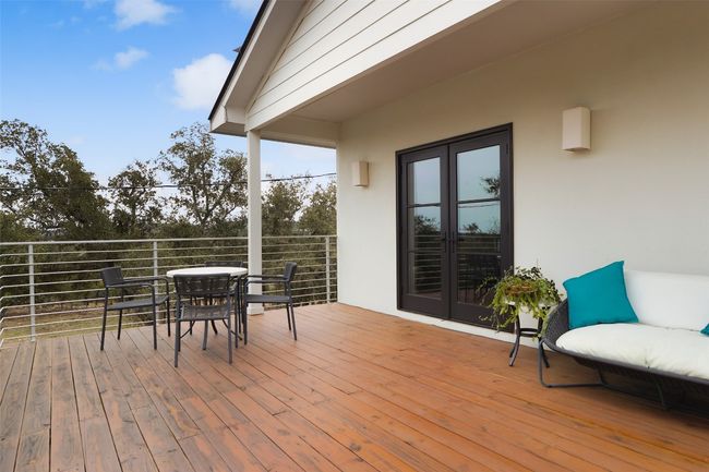 Large back deck featuring French doors and outdoor dining space | Image 29