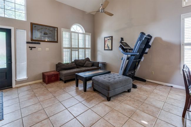 Spacious living area with vaulted ceilings and tiled floors! | Image 4