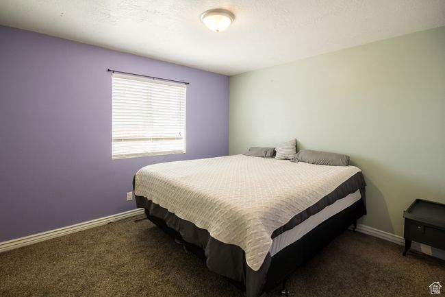 Carpeted bedroom with baseboards | Image 16