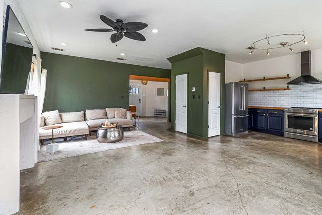 Living room featuring recessed lighting, ceiling fan, visible vents, and finished concrete floors | Image 10