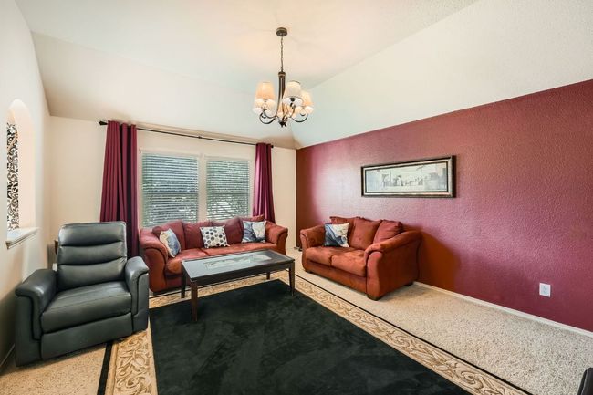 Living area with vaulted ceiling and a chandelier | Image 28