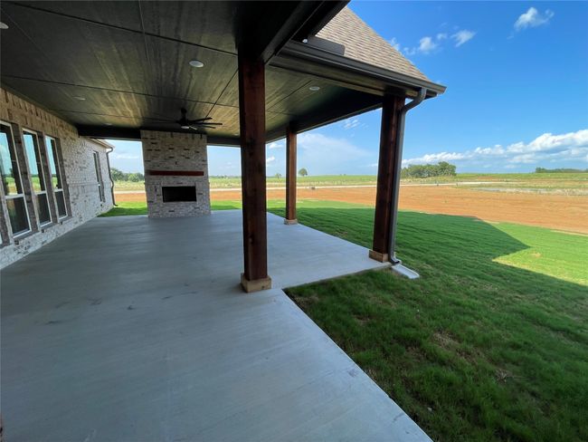 View from expansive covered patio with plenty of space for a outdoor kitchen and a brick wood burning fireplace | Image 36