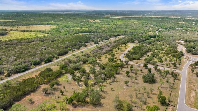 Aerial view of property and surrounding area featuring a heavily wooded area | Image 9