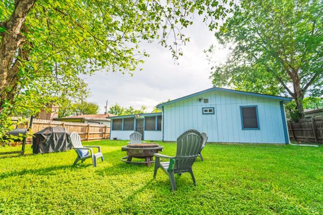 Fenced backyard featuring an outdoor fire pit and a sunroom | Image 31
