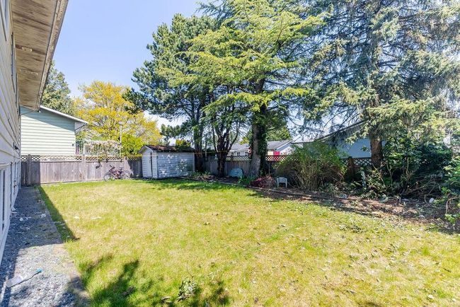 Fenced backyard featuring a shed | Image 26