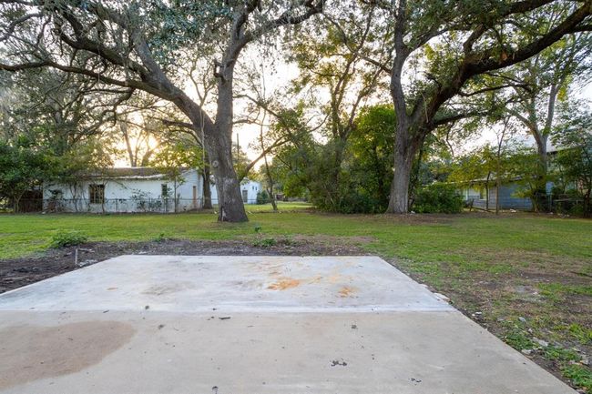 The large fenced backyard offers ample space for children or pets to play. | Image 37
