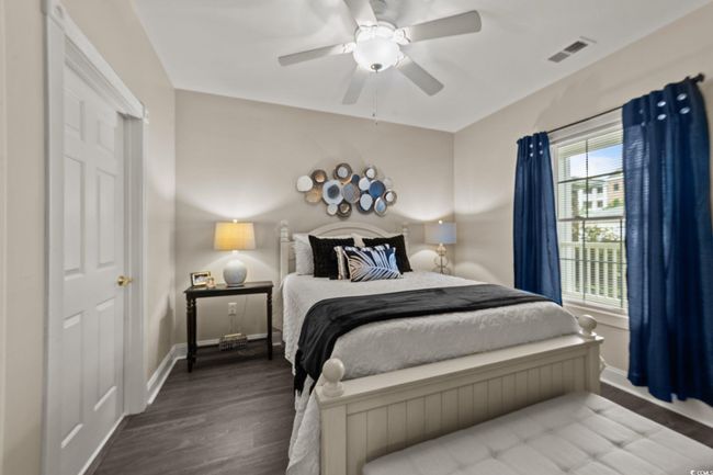 Bedroom featuring wood finished floors, baseboards, and ceiling fan | Image 12