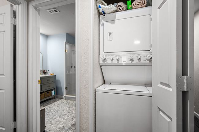 Laundry room featuring estacked washer and dryer | Image 19