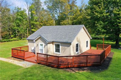 1st House.. Back of property with a wooden deck and a yard | Image 2