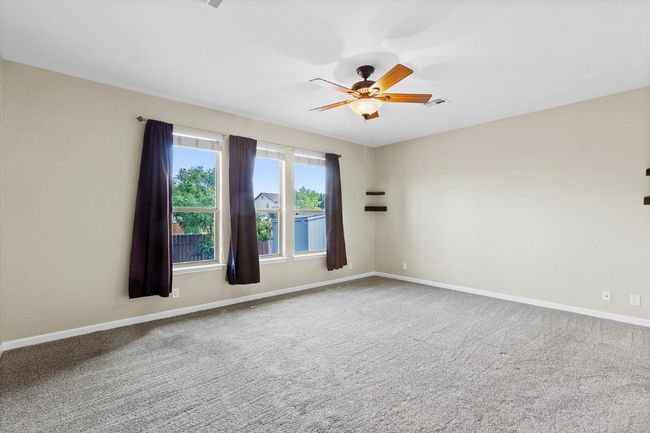 Spare room featuring carpet flooring and ceiling fan | Image 18