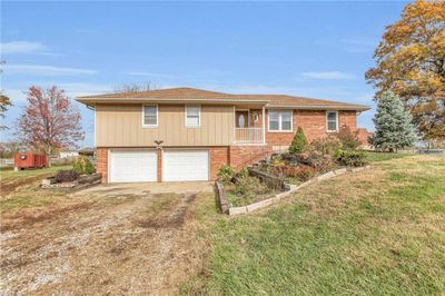 View of front of home with a garage and a front lawn | Image 1