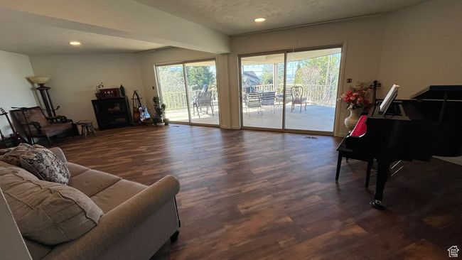 Living area with plenty of natural light, recessed lighting, and wood finished floors | Image 15