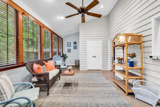 Sitting room with healthy amount of natural light, ceiling fan, lofted ceiling, and wood finished floors | Image 11