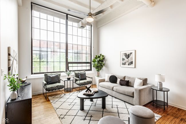 living room with hardwood / wood-style flooring, a towering ceiling, ceiling fan, and beam ceiling | Image 4