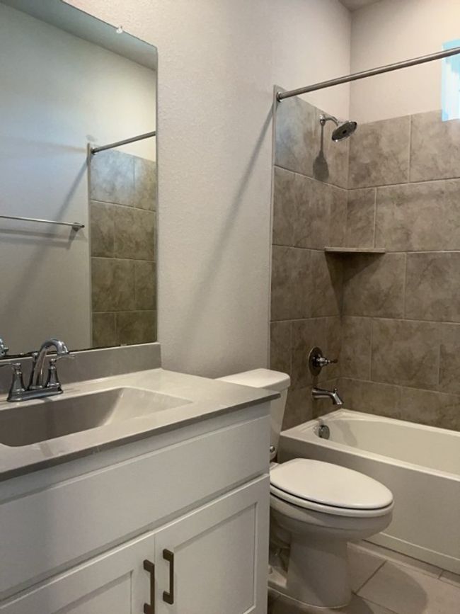 Full bath with vanity, tub / shower combination, and tile patterned floors | Image 31
