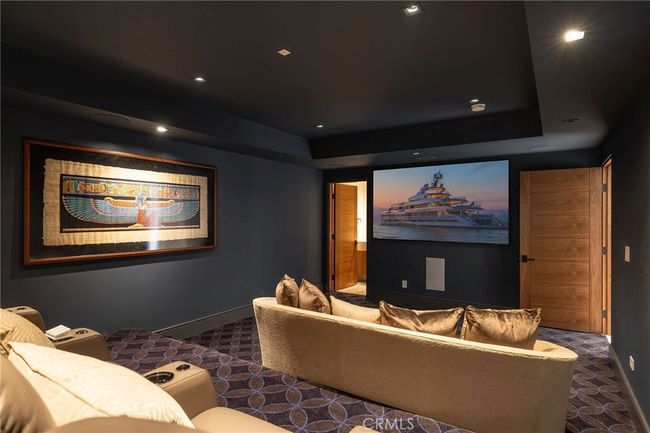 Subterranean, state-of-the-art movie theater with tiered seating and 100” screen is ideal for entertaining. | Image 25