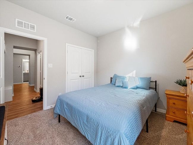 Carpeted bedroom featuring visible vents, a closet, and baseboards | Image 21
