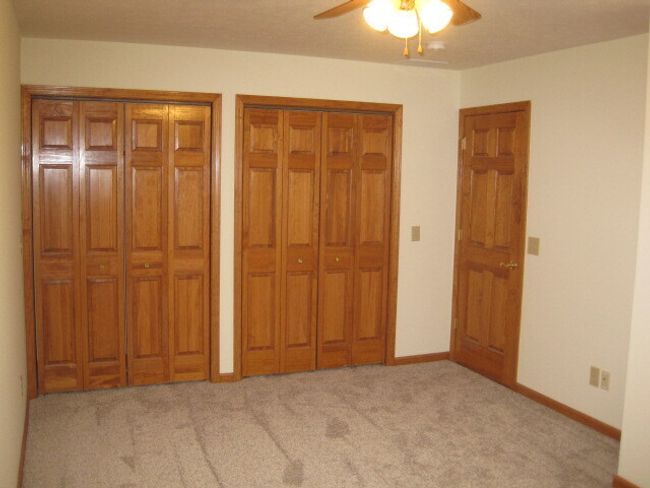 Primary Bedroom with TWO Double Door Closets and also a Ceiling Fan w/Light. New Carpeting! | Image 21