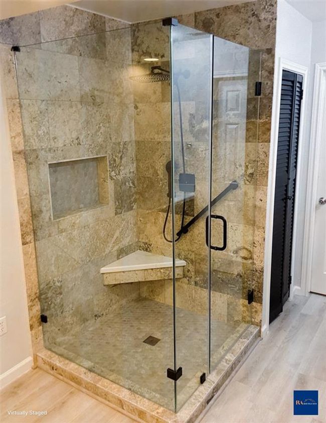 Luxurious shower with modern tile and sleek glass enclosure. | Image 7