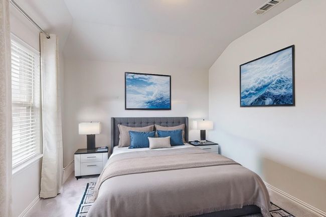 Bedroom with multiple windows, vaulted ceiling, baseboards, and light carpet | Image 11