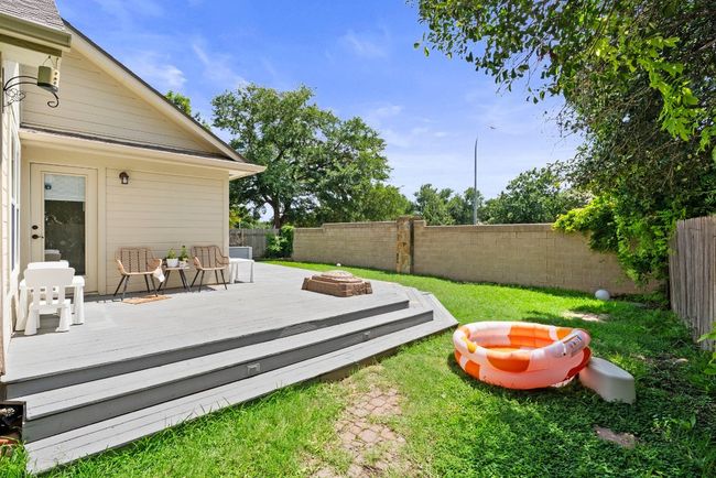 Fenced backyard with a deck and a fire pit | Image 28