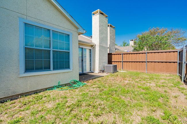 View of yard with a fenced backyard and cooling unit | Image 12