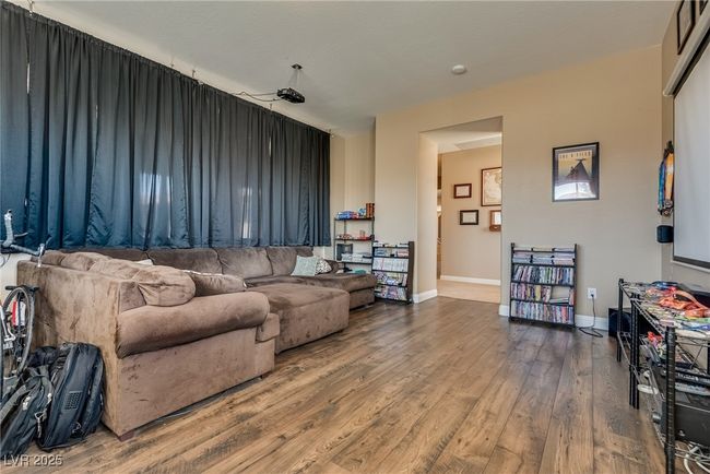 Living room featuring baseboards and wood finished floors | Image 36