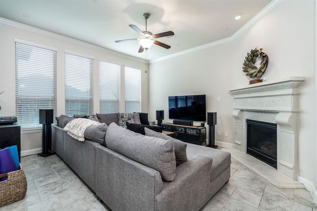 Spacious family room with fireplace and plenty of natural light. | Image 14