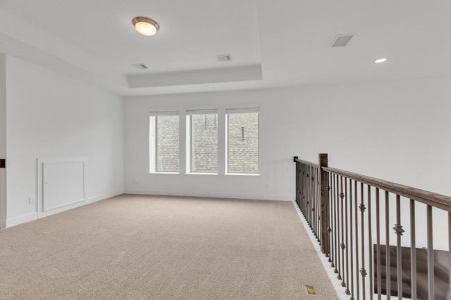 Carpeted empty room featuring baseboards and a raised ceiling | Image 23