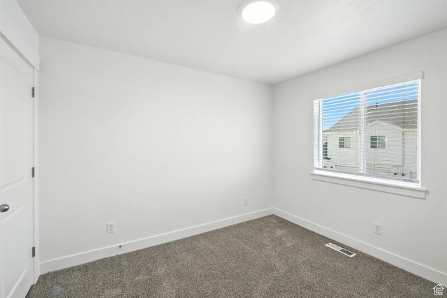 Unfurnished room with dark carpet and baseboards | Image 12