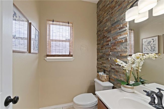 Half bath featuring toilet, vanity, and baseboards | Image 15