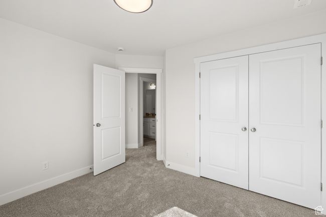 Unfurnished bedroom featuring light colored carpet and a closet | Image 26