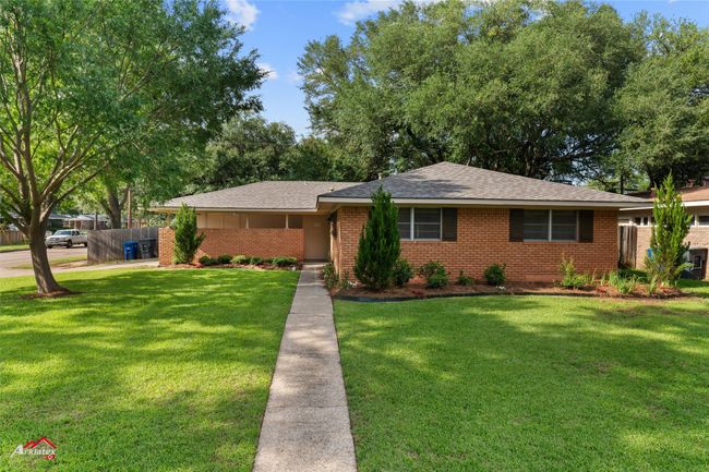 Ranch-style home featuring brick siding and roof with shingles | Image 22