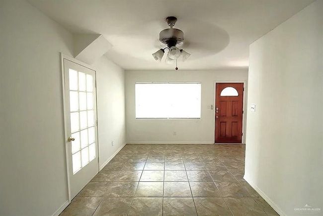 Entryway with a ceiling fan and baseboards | Image 4
