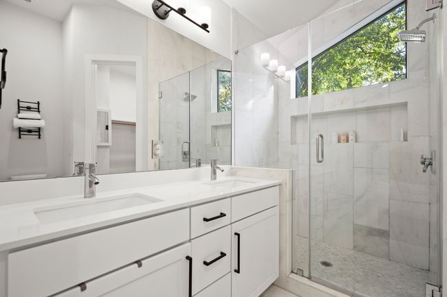 Full bath featuring plenty of natural light, double vanity, and a stall shower | Image 21