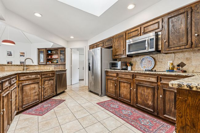 Kitchen featuring stainless steel appliances, tasteful backsplash, light tile patterned floors, and recessed lighting | Image 8