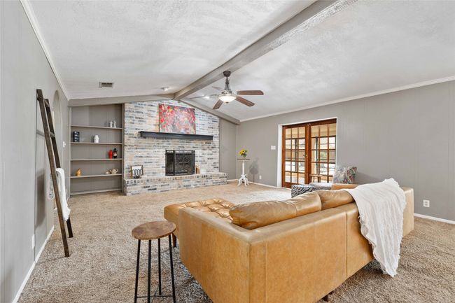 Living room with vaulted ceilings and wood burning fireplace | Image 10