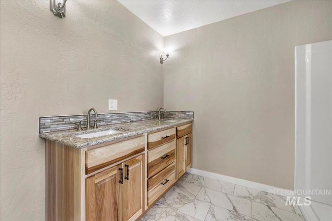 Bathroom featuring marble finish floors and double vanity | Image 6