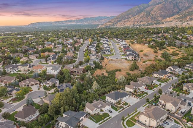 Aerial overview of property's location with mountains and nearby suburban area | Image 12