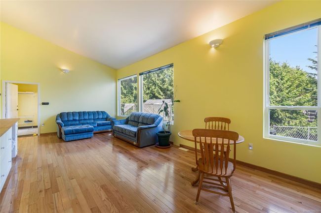 Living room with lofted ceiling, light wood-style floors, and baseboards | Image 38