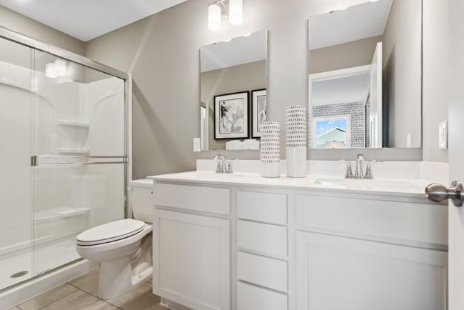 *Photo of model home, actual features may vary. An extension of the owner's suite, this private and spacious bathroom contains a double-vanity. | Image 11