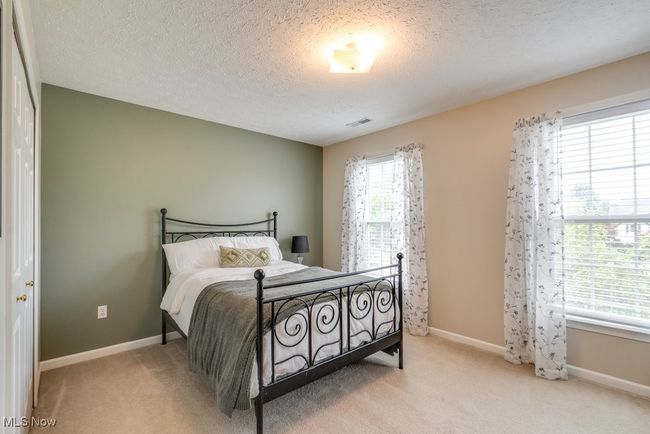 Carpeted bedroom featuring a textured ceiling and baseboards | Image 30