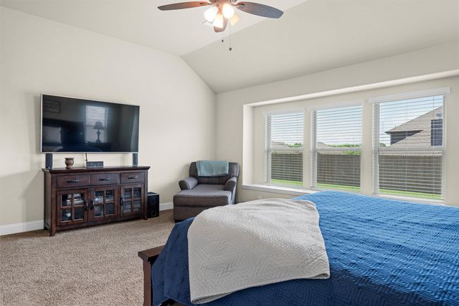 Bedroom featuring carpet floors, lofted ceiling, and ceiling fan | Image 21