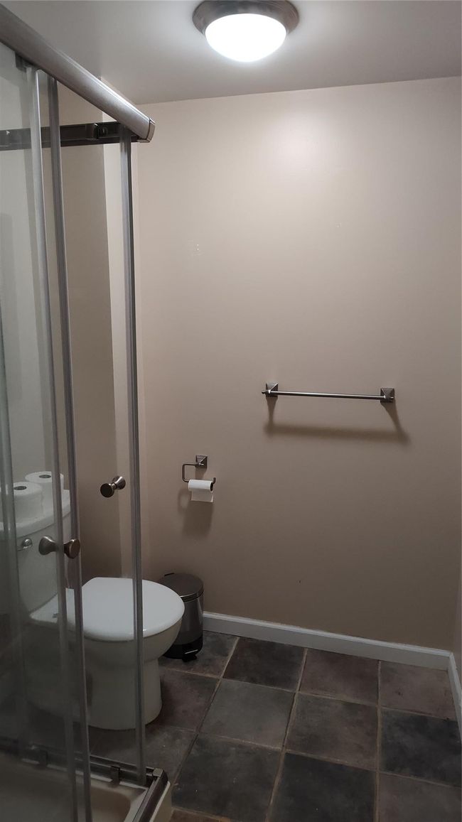 Full bath with toilet, a stall shower, and baseboards | Image 9